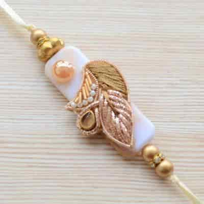 Buy Strands Elegant Off White Beige Bronze and Gold Rakhi for Brother