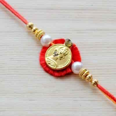 Buy Strands Red Gold Coin Rakhi for Bhaiya