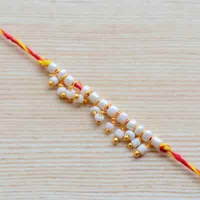 Buy Strands Sacred Mauli Pearl and Tiny Ghungroo Thread Rakhi