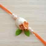 Buy Strands Pearl and Coral Artisanal Elegant Rakhi for Bhaiya