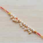 Buy Strands Sacred Mauli Pearl and Tiny Ghungroo Thread Rakhi