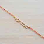 Strands Sacred Mauli Pearl and Tiny Ghungroo Thread Rakhi